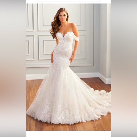 This is a designer wedding dress and the brand is Martin Thornburg